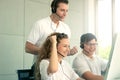 Happy smiling young beautiful woman with headphones work at call center desk consultant raised arm up supervisor motivate team to
