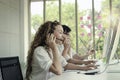 Happy smiling young beautiful woman with headphones working at call center service desk consultant with her teammates  talking Royalty Free Stock Photo