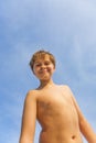 Happy smiling young boy with background blue sky Royalty Free Stock Photo