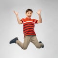 Happy smiling young boy jumping in air Royalty Free Stock Photo