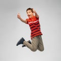 Happy smiling young boy jumping in air Royalty Free Stock Photo