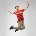 Happy smiling young boy jumping in air Royalty Free Stock Photo