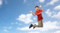 Happy smiling young boy jumping in air over sky Royalty Free Stock Photo