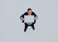 Happy smiling young business man showing blank signboard. Royalty Free Stock Photo