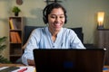 Happy smiling young Business woman with headphone in video call on laptop busy talking - concept of online chat Royalty Free Stock Photo