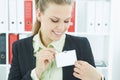 Happy smiling young business woman wearing blank badge.