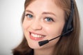 Happy smiling young caucasian woman with headset phone in a call center or office, close up Royalty Free Stock Photo