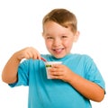 Happy smiling young child eating yogurt Royalty Free Stock Photo