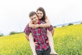 Happy smiling young couple over yellow green meadow Royalty Free Stock Photo