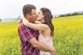 Happy smiling young couple over yellow green meadow Royalty Free Stock Photo