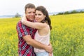 Happy smiling young couple over yellow green meadow Royalty Free Stock Photo