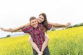 Happy smiling young couple over yellow green meadow Royalty Free Stock Photo