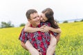 Happy smiling young couple over yellow green meadow Royalty Free Stock Photo