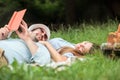 Happy smiling young couple relaxing in a park. Lying on a picnic blanket Royalty Free Stock Photo