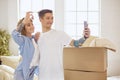 Happy smiling young couple showing a pair of keys of their new house Royalty Free Stock Photo