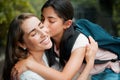 Happy, smiling and young daughter kissing her mother, hugging and greeting before school in the morning. Loving, caring Royalty Free Stock Photo