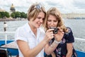 Happy and smiling young women looking on camera screen at pictures Royalty Free Stock Photo