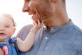 Happy smiling young father and little daughter in his hands having fun outdoors on summer day. family concept. fathers and baby Royalty Free Stock Photo