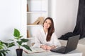 Happy smiling young girl working in the office. Close-up portrait of an office worker. Positive young manager working on business Royalty Free Stock Photo