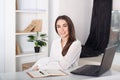 Happy smiling young girl working in the office. Close-up portrait of an office worker. Positive young manager working on business Royalty Free Stock Photo