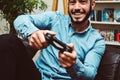 Happy smiling young handsome man playing video games and having fun at home Royalty Free Stock Photo