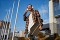 Happy smiling young hipster man skateboarder listening to music in headphones Royalty Free Stock Photo