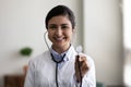 Happy smiling young Indian doctor head shot portrait