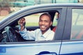 Happy, smiling, young man, buyer sitting in his new blue car showing keys Royalty Free Stock Photo