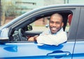 Happy smiling young man buyer sitting in his new car Royalty Free Stock Photo