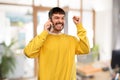 Happy smiling young man calling on smartphone Royalty Free Stock Photo
