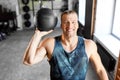 Happy smiling young man with medicine ball in gym Royalty Free Stock Photo