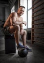 happy smiling young man with medicine ball in gym Royalty Free Stock Photo