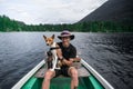 Traveller man with best friend dog on boat Royalty Free Stock Photo