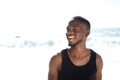 Happy smiling young man standing at the beach Royalty Free Stock Photo