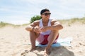 Happy smiling young man sunbathing on beach towel Royalty Free Stock Photo