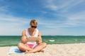 Happy smiling young man with tablet pc on beach Royalty Free Stock Photo