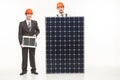 Happy smiling young men solar panel Royalty Free Stock Photo