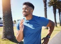 Happy smiling young mixed race fit man enjoying a run in a park during summer alone. One cheerful hispanic male smiling Royalty Free Stock Photo