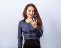Happy smiling young positive woman with long curly hairstyle in business office clothing talking on mobile phone and looking up on Royalty Free Stock Photo