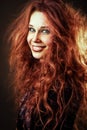 Happy smiling young redhead woman with long curly hair Royalty Free Stock Photo