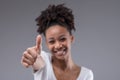 Happy smiling young teenage girl giving a thumbs up Royalty Free Stock Photo