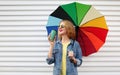 happy smiling young woman with colorful umbrella and cup of coffee on a white background Royalty Free Stock Photo