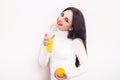 Happy smiling young woman drinking orange juice Royalty Free Stock Photo