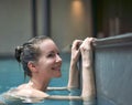 Happy woman enjoying indoor swimming pool Royalty Free Stock Photo