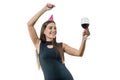 Happy smiling young woman with a glass of red wine, in party hats, black cocktail dress. On white isolated background girl having Royalty Free Stock Photo