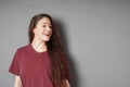 Happy smiling young woman in her 20s with natural make-up and brunette long hair looking to side Royalty Free Stock Photo