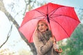 Cheerful pretty girl holding umbrella while strolling outside Royalty Free Stock Photo