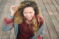 Happy smiling young woman portrait dressed in gray knitted jersey