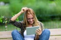 Happy smiling young woman scratching her head Royalty Free Stock Photo