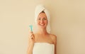 Happy smiling young woman with white clean teeth holding razor blade, shaving machine, caucasian girl dries her wet hair with Royalty Free Stock Photo